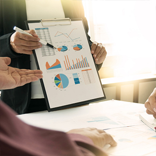 Boardroom setting with highlighting data on a clipboard
